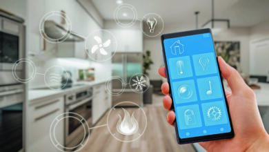 Smart home technology interface on smartphone app. Screen with augmented reality view of internet of things connected objects in the apartment interior. Person is holding device.