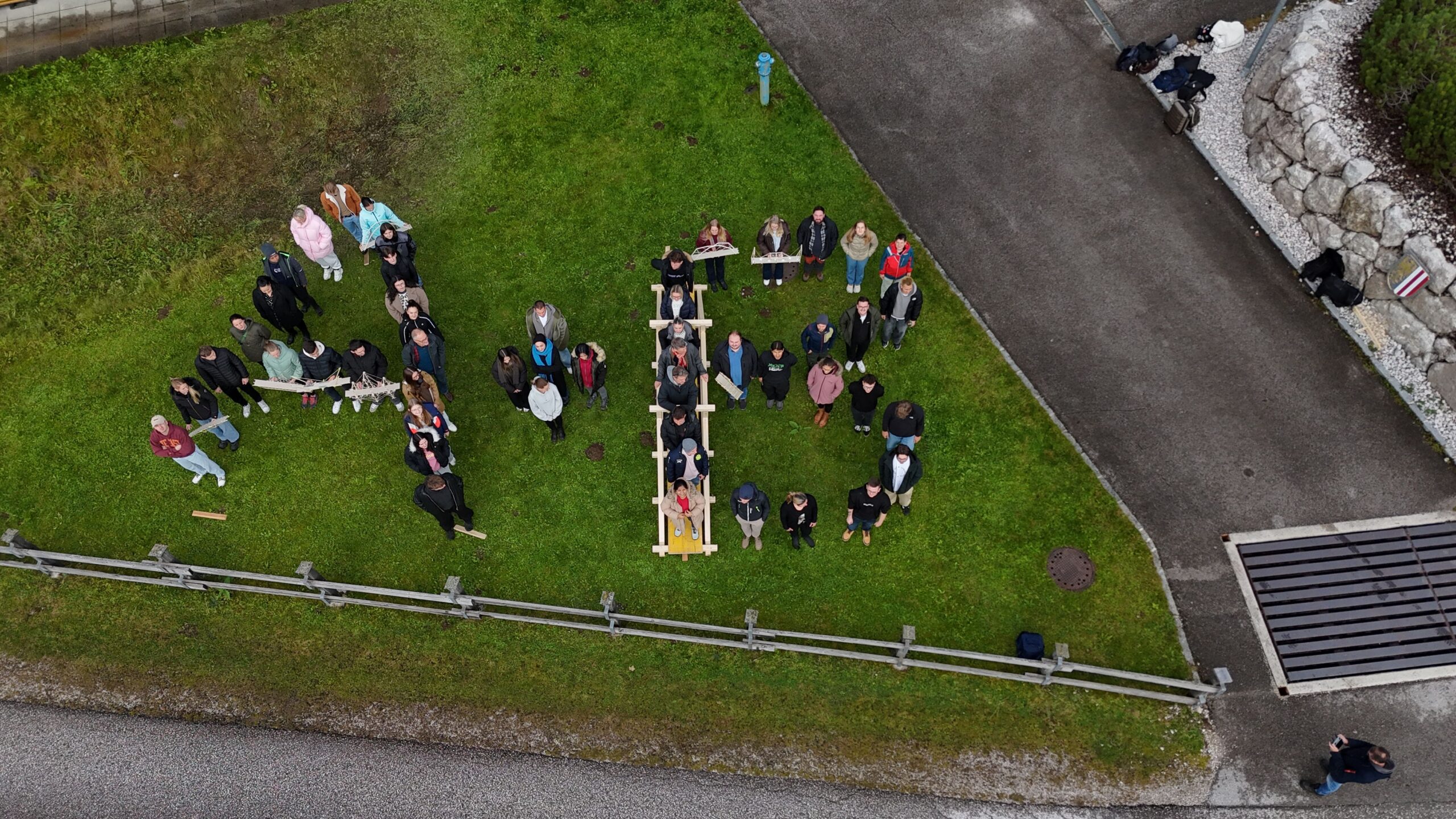 Luftbild: Personen bilden die Buchstaben A+B