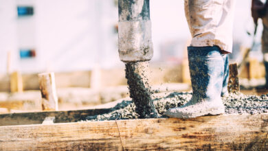 Details of concrete pouring during construction of house. Industrial details, machinery and people