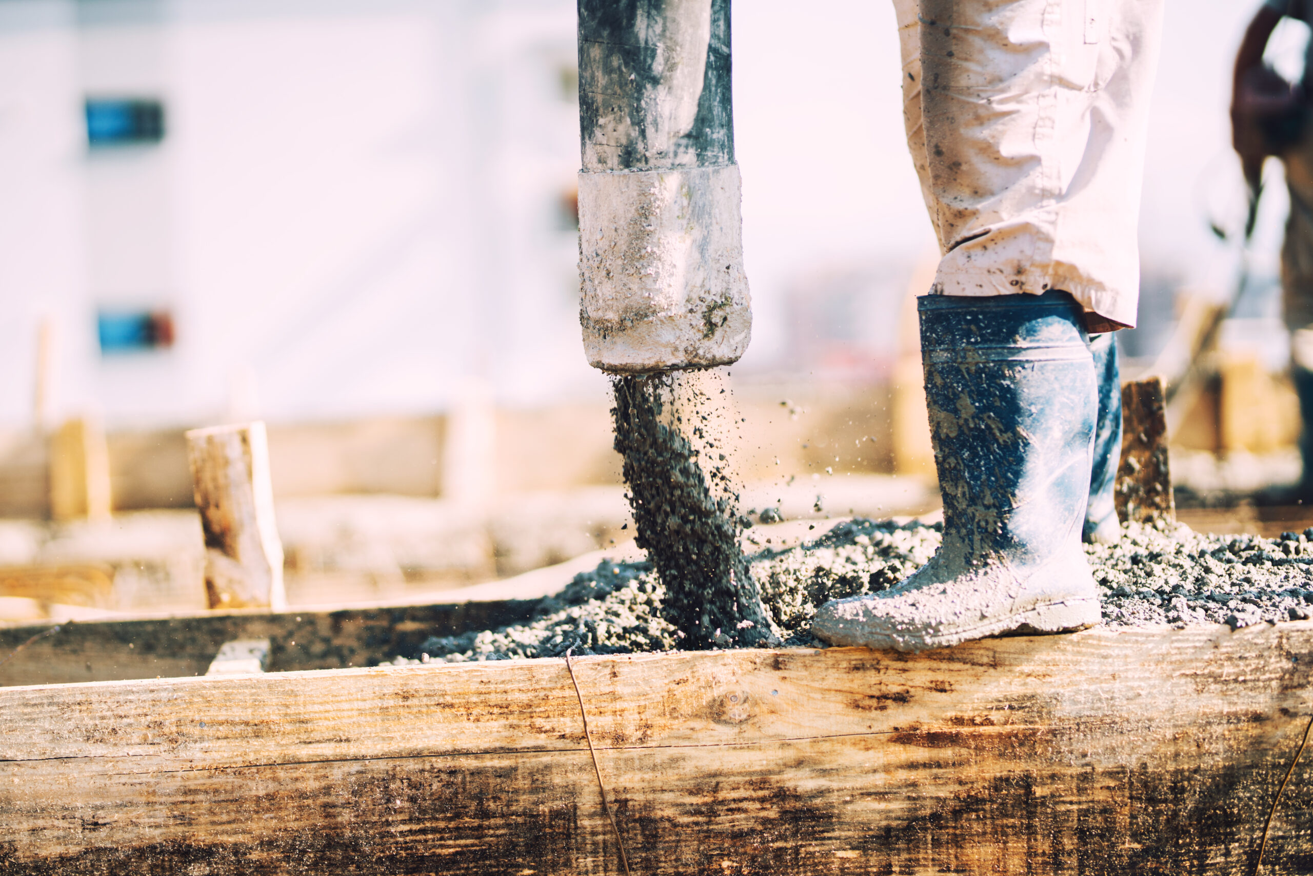 Details of concrete pouring during construction of house. Industrial details, machinery and people