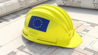 Construction industry safety in EU. European Union flag hardhat yellow color on residential building project blueprint plans, 3d illustration