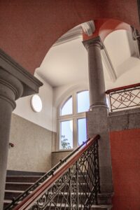 Die eingesetzten Glasrahmenelemente lassen Tageslicht tief in die Flurzone und schaffen klare, zurückhaltende Übergänge im denkmalgeschützten Schulbau. © Swisspacer