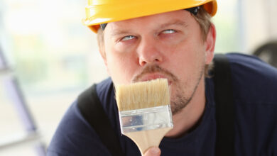 Arm of smiling worker hold brush portrait. Manual job workplace DIY inspiration improvement fix shop yellow helmet hard hat joinery startup idea industrial education profession career concept